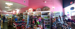 A panoramic view of Bentley's Biscuits & Bones. Retail items are show in the front, while treats and cookies are in a the refrigerated case on the side. In the left back corner is the bakery where birthday cakes are made fresh each morning.